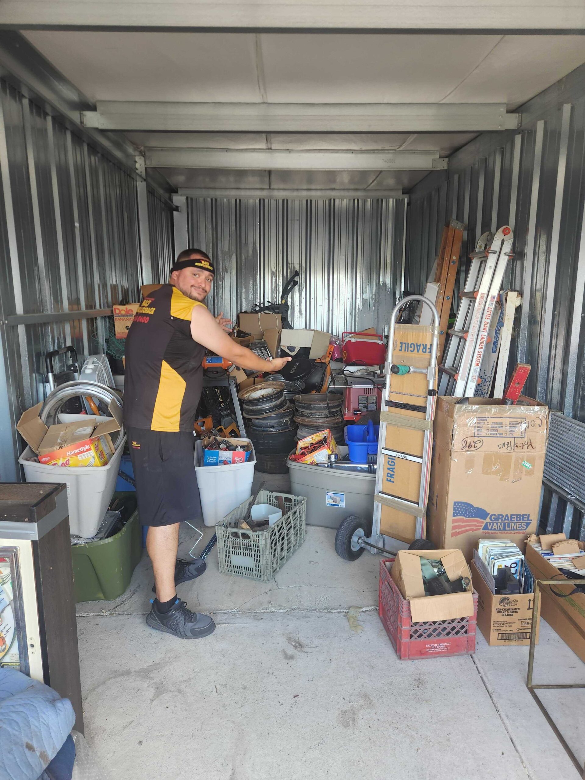MACs mover organizing customer belongings inside a self-storage unit at the Lake Geneva facility
